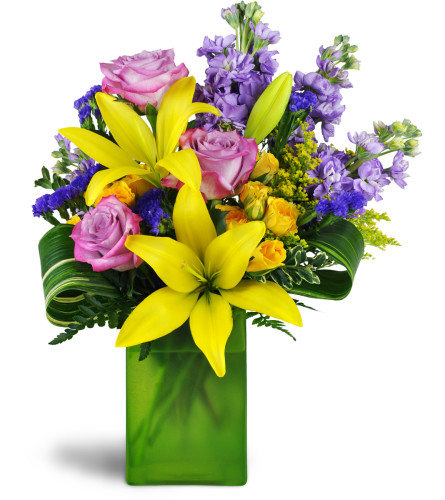 Springtime Kiss™ - Deluxe. An arrangement by Avenue Flowers and Gifts. Treat them to lavender roses, sunny yellow lilies, purple stock, and more...
