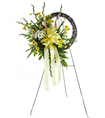 Expressions of Love. An arrangement by Avenue Flowers and Gifts. Gladiolus and daisies are gracefully arranged for display at the funeral home or...