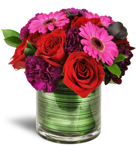 Raspberry Bliss™. An arrangement by Avenue Flowers and Gifts. Mini Gerbera daisies, carnations, mini calla lilies, and red roses are stylishly...