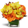 Golden Morning™ - Deluxe. An arrangement by Avenue Flowers and Gifts. Yellow cymbidium orchids and large orange rose blooms are arranged in an...