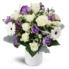 Oasis in Bloom™ - Deluxe. An arrangement by Avenue Flowers and Gifts. Featuring white spray roses, purple tulips, and more..