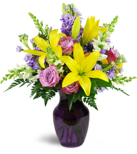 Sprightly Spring™. An arrangement by Avenue Flowers and Gifts. Yellow Asiatic lilies bloom bright with lavender roses, stock, and creamy white...