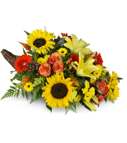 Giving Thanks Cornucopia™ - Deluxe. An arrangement by Avenue Flowers and Gifts. Lilies, sunflowers, mini Gerbera daisies, and more overflow from a...