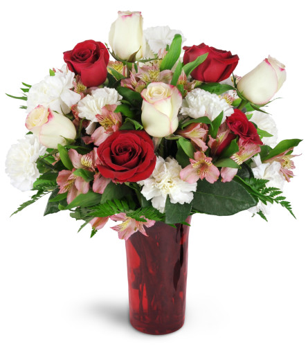Romance of Roses™ - Deluxe. An arrangement by Avenue Flowers and Gifts. Give a stunning gift of red and cream roses arranged with carnations,...
