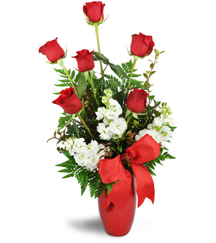 True To My Heart™. An arrangement by Avenue Flowers and Gifts. Six red roses are timelessly arranged with white stock in a red metallic vase..