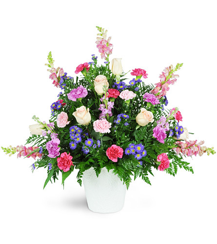 Sweet Comfort. An arrangement by Avenue Flowers and Gifts. Soft pink roses, carnations, snapdragons, and asters are arranged for display at the...