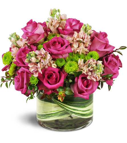 Hot Pink Valentine™. An arrangement by Avenue Flowers and Gifts. Fuchsia roses, pink stock, and Kermit poms are lovingly arranged in a leaf-lined...