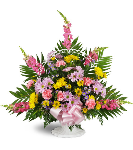 Shades of Remembrance™. An arrangement by Avenue Flowers and Gifts. Pink snapdragons, green fern fronds, yellow and purple daisies, and pink...