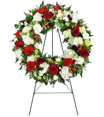 Passionate Faith Sympathy Wreath™. An arrangement by Avenue Flowers and Gifts. This standing sympathy wreath features red roses, white carnations,...