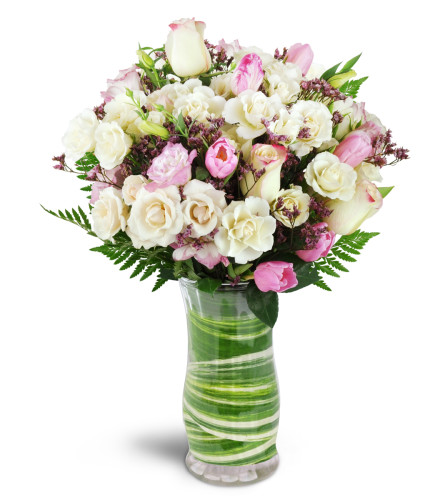 Sweetest Valentine™ - Deluxe. An arrangement by Avenue Flowers and Gifts. Roses and spray roses are arranged with tulips, lisianthus, and more in...