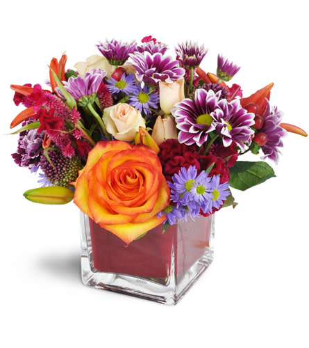Remarkable Red!™. An arrangement by Avenue Flowers and Gifts. Roses, lilies, spray roses, and more are arranged with care in a modern cube vase..