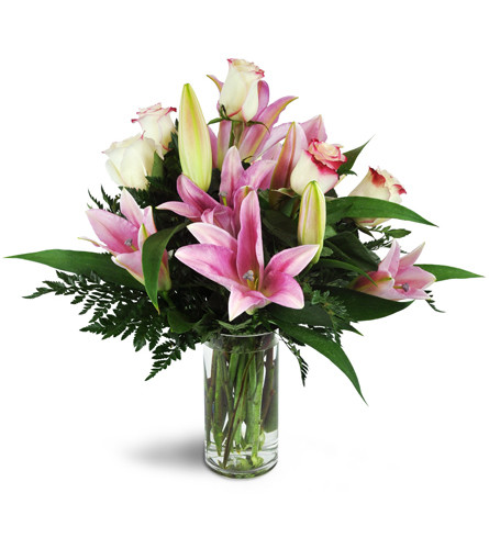 Alluring Roses and Lilies™. An arrangement by Avenue Flowers and Gifts. A sweet assortment of pink lilies and roses are arranged in a glass...