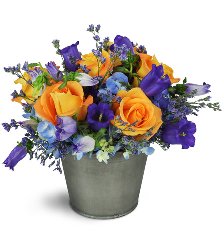 Fall Splendor™. An arrangement by Avenue Flowers and Gifts. Orange roses, purple bellflowers, and more are delightfully arranged in a tin container..