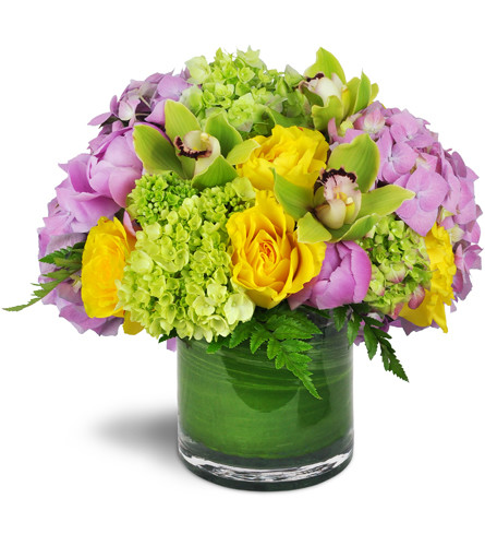 Summer's Bounty Vase™. An arrangement by Avenue Flowers and Gifts. Green and pink hydrangeas, yellow rose blooms, and distinctive green Cymbidium...