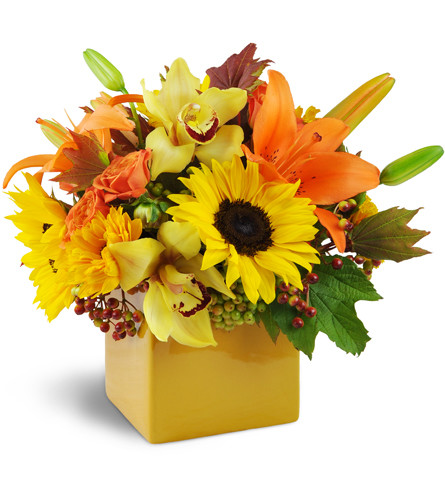 Sunshine Surprise™. An arrangement by Avenue Flowers and Gifts. Joyful sunflowers, yellow cymbidium orchids, lilies, spray roses, and more burst...