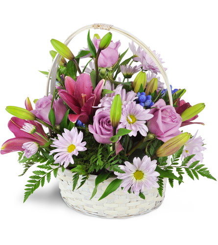 Basket Full of Dreams™. An arrangement by Avenue Flowers and Gifts. An assortment of purple-hued roses, daisies, lilies, and more are arranged in...