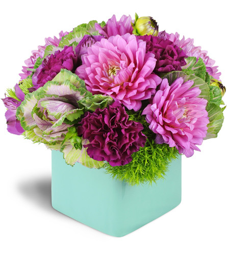 Sunrise Horizons™. An arrangement by Avenue Flowers and Gifts. Pink dahlias, purple carnations, alstroemeria, kale, and green dianthus are...