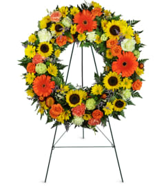 Heavenly Dawn Sunflower Wreath™. An arrangement by Avenue Flowers and Gifts.