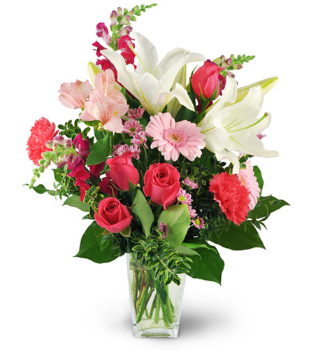 Love Blooms. An arrangement by Avenue Flowers and Gifts. White oriental lilies, pink roses, carnations, mini Gerbera daisies, snapdragons,...