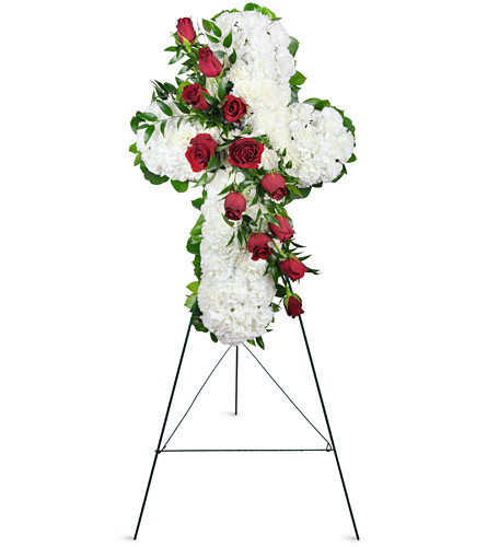 Enduring Faith. An arrangement by Avenue Flowers and Gifts. 75 white carnations and a dozen deep red roses are gracefully arranged with accents of...