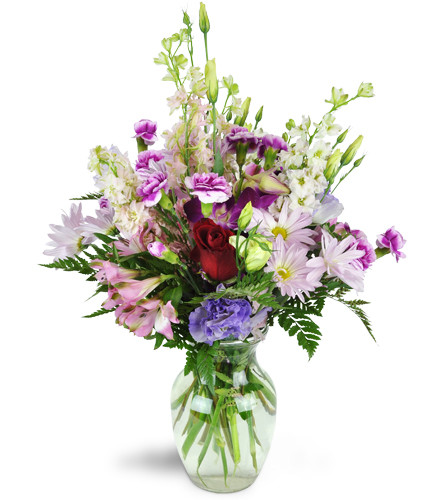 Morning in the Garden™. An arrangement by Avenue Flowers and Gifts. Roses, mini carnations, larkspur, Peruvian lilies, and a stem of Dendrobium...