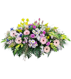 Garden Path Casket Spray. An arrangement by Avenue Flowers and Gifts.