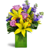 Springtime Kiss™ - Deluxe. An arrangement by Avenue Flowers and Gifts. Treat them to lavender roses, sunny yellow lilies, purple stock, and more...