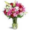 Blushing Heart Bouquet™ - Deluxe. An arrangement by Avenue Flowers and Gifts. Deep red roses, lush lilies, and pretty pink Gerbera daisies are...
