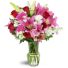 Blushing Heart Bouquet™ - Premium. An arrangement by Avenue Flowers and Gifts. Deep red roses, lush lilies, and pretty pink Gerbera daisies are...