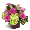 Peek of Chic™ - Deluxe. An arrangement by Avenue Flowers and Gifts. Hot-pink roses, green hydrangea, and pink Peruvian lilies are accented with...