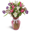 Home Sweet Spring™ - Premium. An arrangement by Avenue Flowers and Gifts. Colorful tulips and waxflower are arranged in a pretty glass vase..