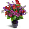 Romance Medley™ - Deluxe. An arrangement by Avenue Flowers and Gifts. Purple Peruvian lilies are arranged with stunning red spray roses and stock....