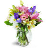Sweet Symphony™ - Standard. An arrangement by Avenue Flowers and Gifts. Mauve lilies, blue iris, pink lisianthus, and more are arranged in a...